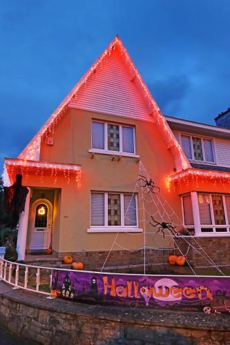 a house decorated for halloween with lights on it at Potter's Place by Ardenne Places in Theux