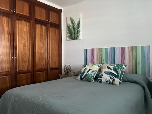 a bedroom with a bed and wooden cabinets at Casa Fatima in Santa Cruz de la Palma