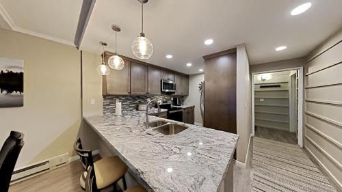 a kitchen with a marble counter top in a room at Spacious 2 BR Units at 1849 Condos with FREE Pool, Parking & Wifi in Mammoth Lakes