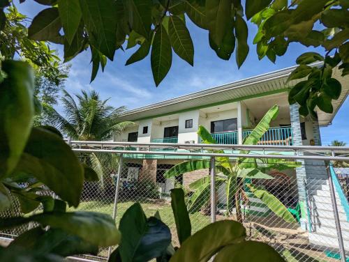 a view of a house from behind a fence at Charlina Inn Panglao in Panglao