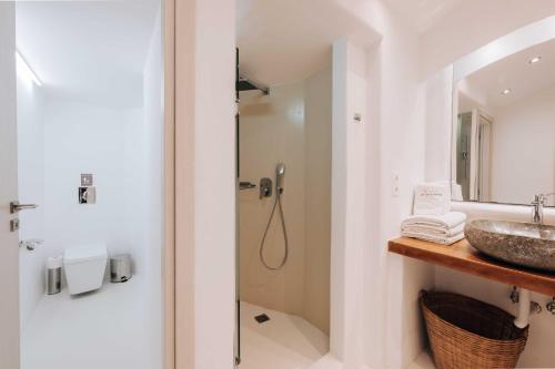 a bathroom with a sink and a shower at My Mykonos Hotel in Mýkonos City