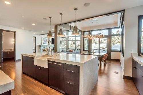 a kitchen with a large island and a dining room at Luxury Five Bedroom Private Home with stunning Park City views home in Park City