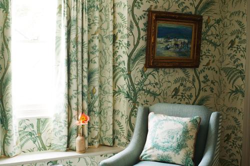 a room with a chair and a picture on the wall at Red Lion Hotel in Clovelly