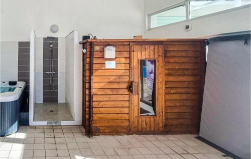 a wooden door in a bathroom with a shower at 1 Bedroom Stunning Home In Dolus-dolron in Dolus d'Oléron