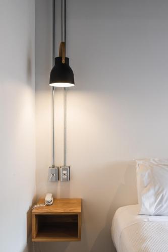 a bedroom with a bed and a table with a lamp at Hotel Big Sur in Puerto Natales