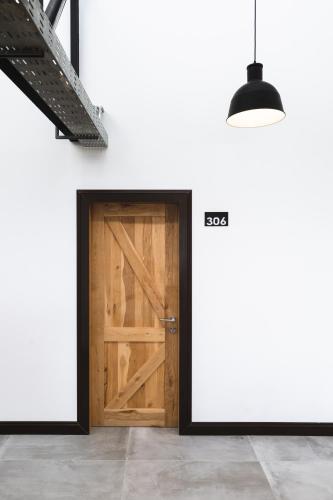 a wooden door in a room with two billboards at Hotel Big Sur in Puerto Natales