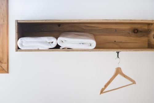 a wooden shelf with two towels on it at Hotel Big Sur in Puerto Natales