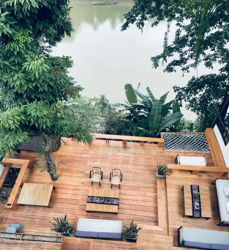 an overhead view of a patio with chairs and a pond at Moonlight Champa Riverview in Luang Prabang