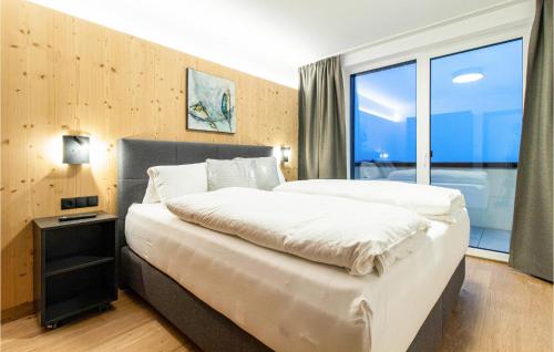 a bedroom with two beds and a large window at 2 Bedroom Cozy Apartment In Zams in Zams