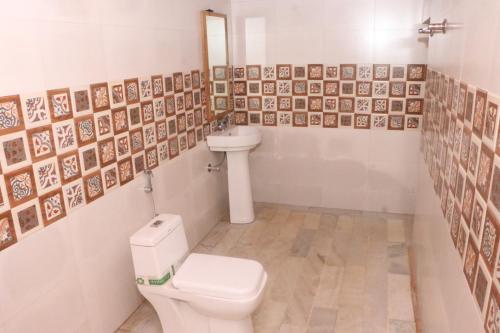 a bathroom with a toilet and a sink at Marina Dessert Camp in Sām