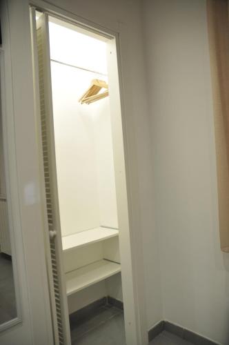 a door of an empty refrigerator with shelves at Casa Monì in Naples
