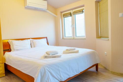 a bedroom with a bed with two towels on it at Centrally Located Apartment in Varna in Varna City
