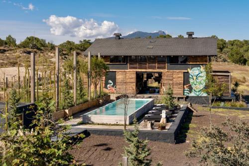 a house with a swimming pool in front of it at Japoneza Retreat Nakamura 