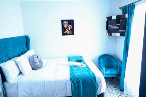 a bedroom with a bed with a person laying on it at El-Gibor Best Guest House in Cape Town