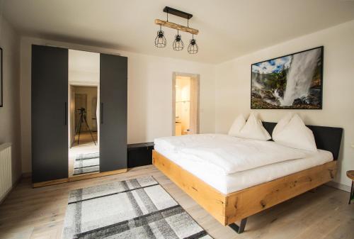a bedroom with a bed and a mirror at Christinenhof Top 6 in Lofer