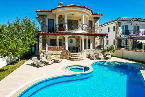 a house with a swimming pool in front of a house at Villa Ahmet Dalyan 4 bedrooms in Dalyan