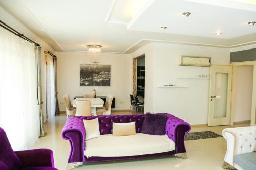 a living room with a purple couch and a table at Villa Ahmet Dalyan 4 bedrooms in Dalyan