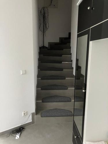 a staircase in a room with a mirror and a stair case at Jeannette in Balingen