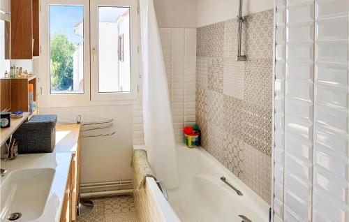 a bathroom with a tub and a sink and a shower at Amazing Apartment In Triel-sur-seine With 2 Bedrooms And Wifi in Triel-sur-Seine