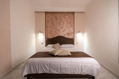 a bedroom with a large bed with two pillows on it at Villa Edelweiss in Bacoli