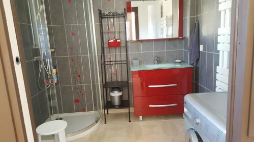 a bathroom with a red sink and a tub at Tranquillité B&B in Cuxac-dʼAude