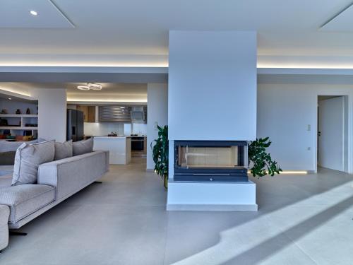 a living room with a couch and a fireplace at Forecastle in Keratea