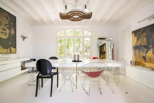 une salle à manger avec une table et des chaises en verre dans l'établissement Villa Alesia, à Paris