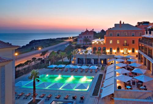 an aerial view of a hotel with a pool and a beach at Grande Real Villa Itália Hotel & Spa in Cascais