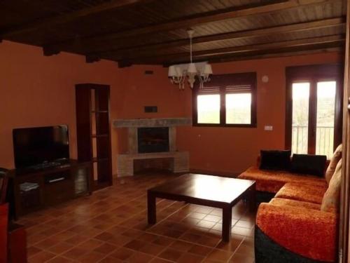 a living room with a couch and a coffee table at Apartamentos en sierra de gata ALMA in Villamiel