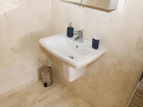a bathroom with a white sink in a room at Cherry Fields in Chesterfield