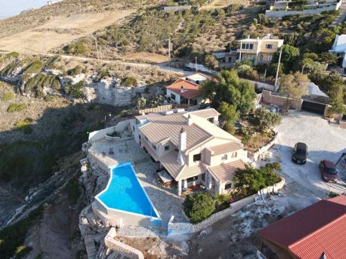 an aerial view of a house with a swimming pool at Forecastle in Keratea