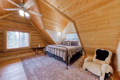 a bedroom with a bed and a ceiling fan at Woodland Wonder in Brian Head