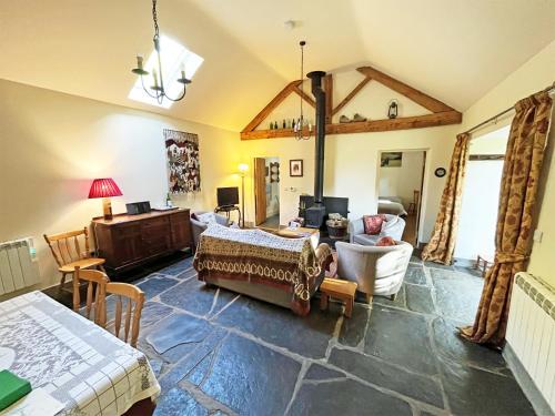 a large living room with a bed and a desk at Drovers Retreat in Llandrindod Wells