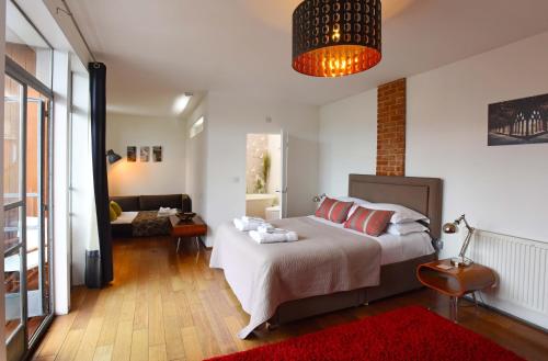 a bedroom with a bed and a living room at Cedar House Canterbury in Canterbury