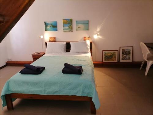 a bedroom with a bed with two pillows on it at SW Villa Corail - Trou aux Biches in Trou aux Biches