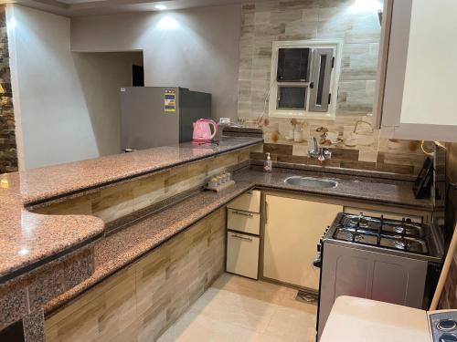 a kitchen with a counter top and a sink at Alzohour Family condo with panoramic sea view in Alexandria