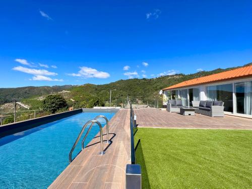 a backyard with a swimming pool and a house at Casas Capela by O'Porto Seven in Ferral