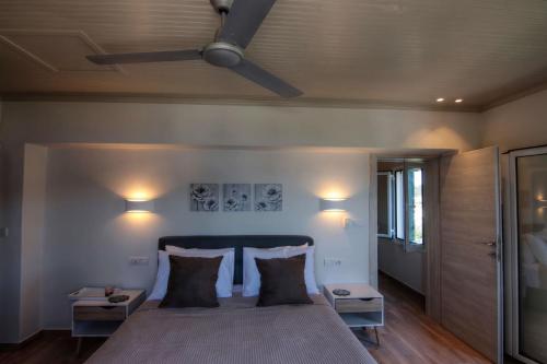 a bedroom with a bed with two pillows and a ceiling at Fiskardo Beach House in Fiskardo