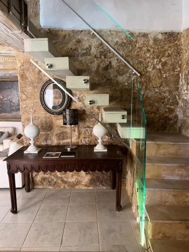 a room with a table with a mirror and stairs at Experience Museum in Agrigento