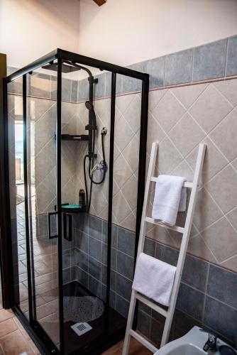 a bathroom with a shower with a ladder next to a sink at B & B CA’ D’ OLINA in Pavullo nel Frignano