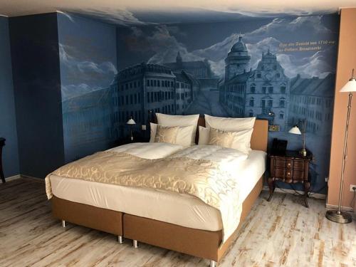 a bedroom with a large bed with a painting on the wall at Gästehaus Luise in Gotha