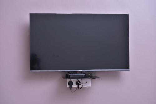 a flat screen tv hanging on a wall at Katente Country Resort in Kyegegwa