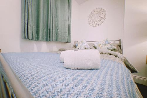 a bedroom with a bed with two pillows on it at Cosy & Comfortable - Heart of Hove - Beach Getaway in Brighton & Hove