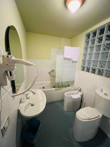 a bathroom with a sink and a toilet and a tub at hotel garni Santa Caterina in Orta San Giulio