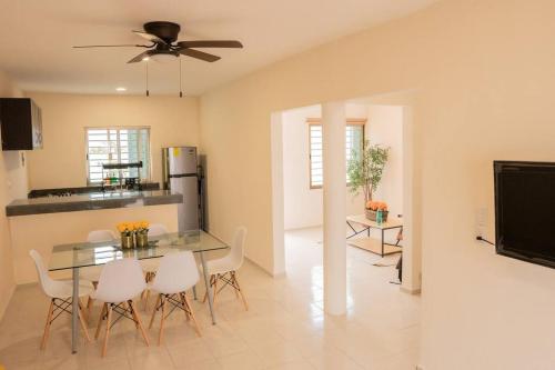 a kitchen and dining room with a table and chairs at acogedora casa con hospedaje para 2 personas in Chetumal