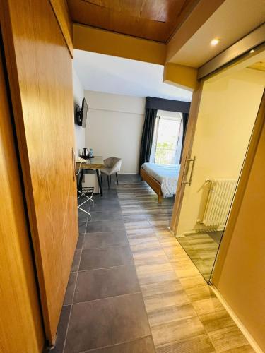 a hallway with a room with a bed and a table at hotel garni Santa Caterina in Orta San Giulio