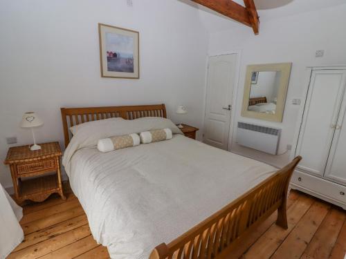 a bedroom with a large bed and a wooden floor at Rock House in Narberth
