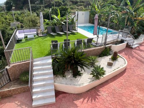 a swimming pool with a staircase leading to a resort at Casa Rural Altaret in Callosa de Ensarriá