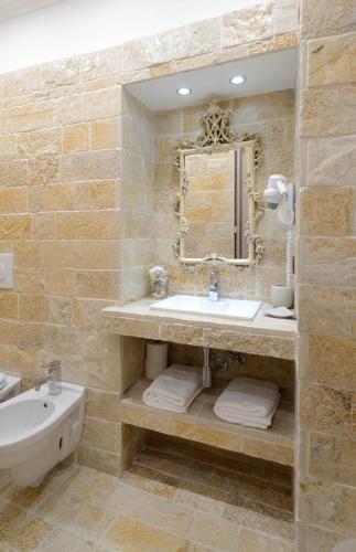 a bathroom with a sink and a mirror and a tub at Dependance Ludovica in Termoli