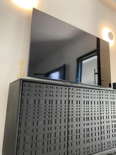 a bathroom with a large mirror on the wall at no.21house. Α Beach house in Rio,Patras in Rio